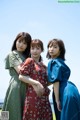 A group of three young women standing next to each other.