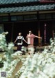 A couple of women standing next to each other in front of a building.